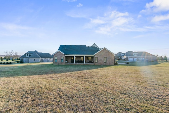 rear view of property with a lawn