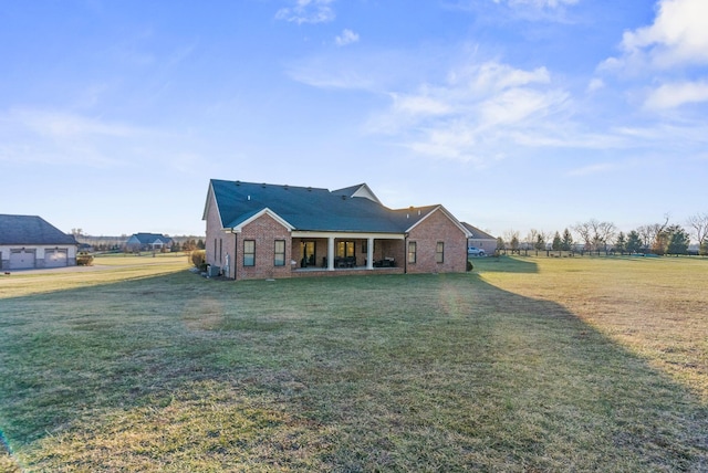 view of front of home with central AC and a front lawn