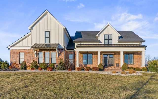 view of front of house with covered porch and a front lawn