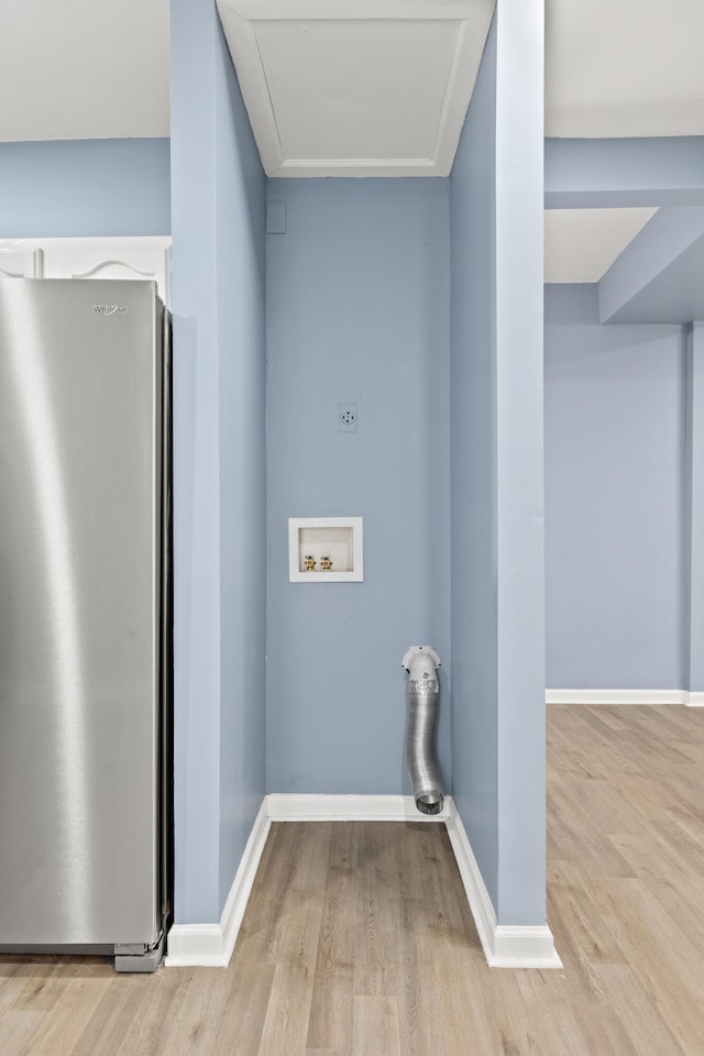 clothes washing area with washer hookup and light wood-type flooring