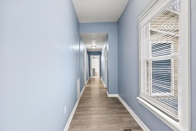 hall with light wood-type flooring