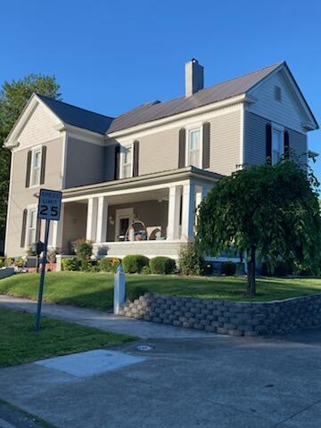 view of front of property with a front yard and a porch