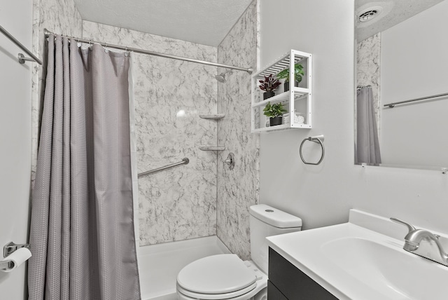 bathroom featuring toilet, vanity, a textured ceiling, and walk in shower