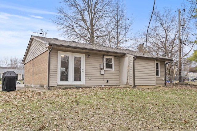 rear view of house with a lawn