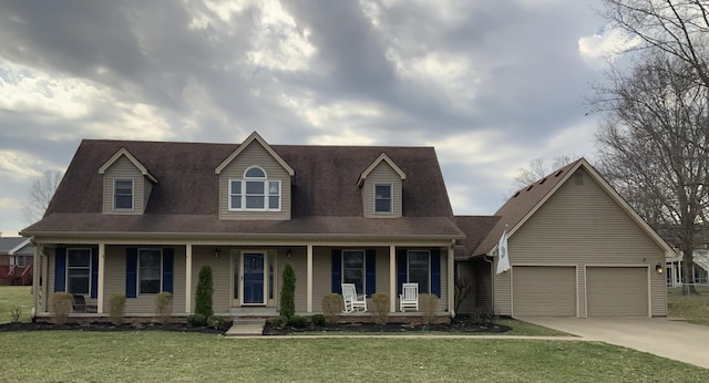 view of front of home featuring covered porch, an attached garage, concrete driveway, and a front lawn