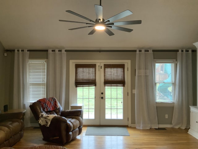 interior space with french doors, baseboards, ceiling fan, and wood finished floors