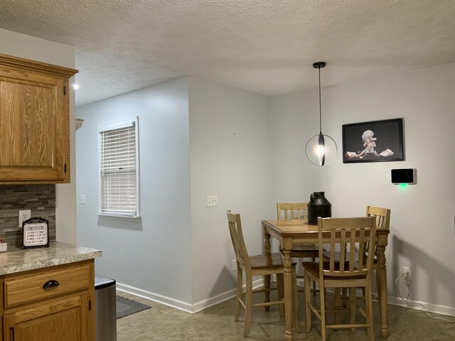 dining space with a textured ceiling