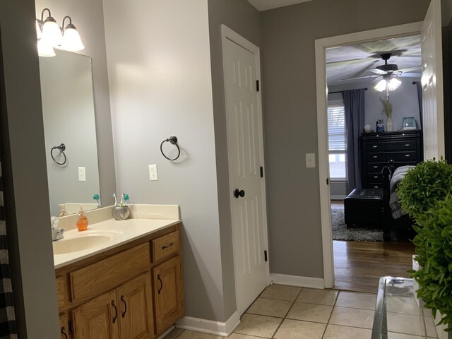 bathroom featuring tile patterned flooring, vanity, and ceiling fan