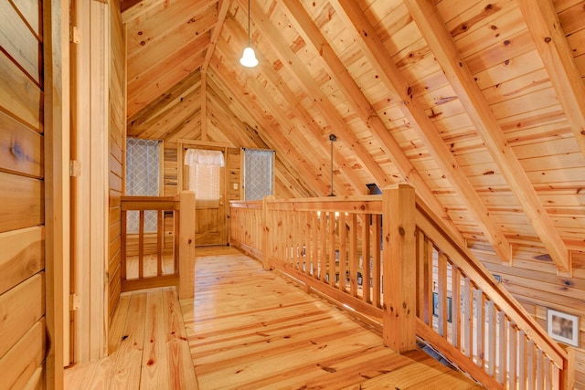 bonus room with vaulted ceiling with beams, wood walls, light wood-type flooring, and wooden ceiling