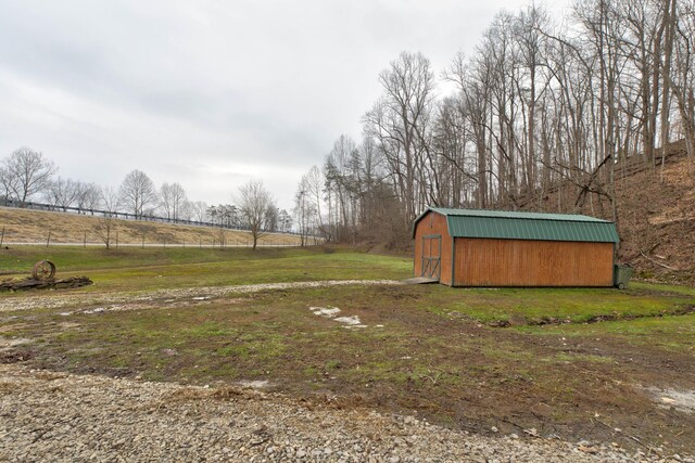 view of yard with a rural view and a storage shed