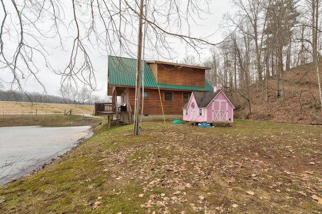 rear view of property with a lawn