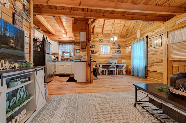 living room featuring wood ceiling, wooden walls, and light hardwood / wood-style flooring