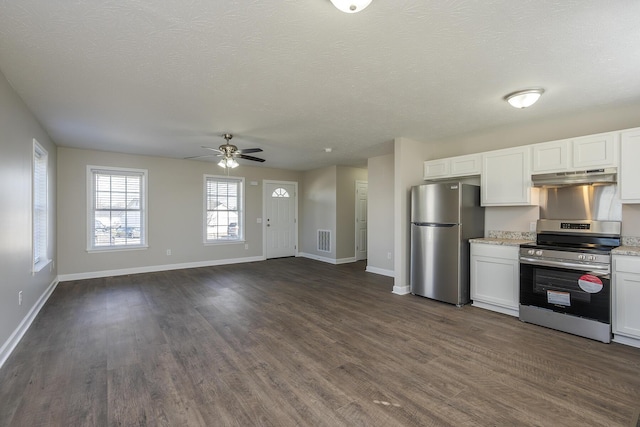 kitchen with white cabinetry, stainless steel appliances, dark wood-type flooring, and a textured ceiling