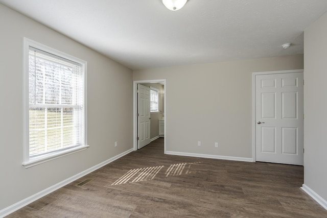 unfurnished room with dark hardwood / wood-style flooring