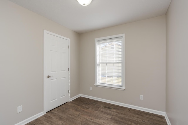 empty room with dark hardwood / wood-style floors