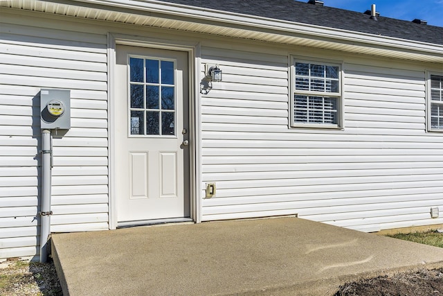 view of exterior entry featuring a patio area