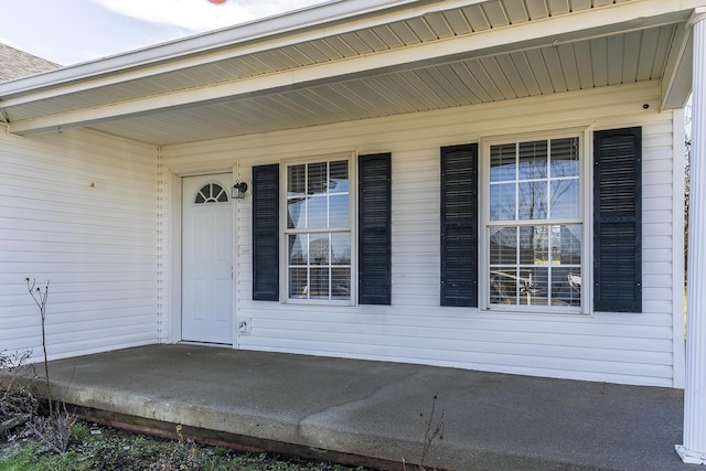 view of exterior entry featuring covered porch