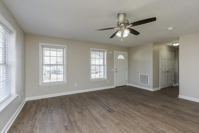 entrance foyer featuring dark hardwood / wood-style flooring, ceiling fan, and a textured ceiling