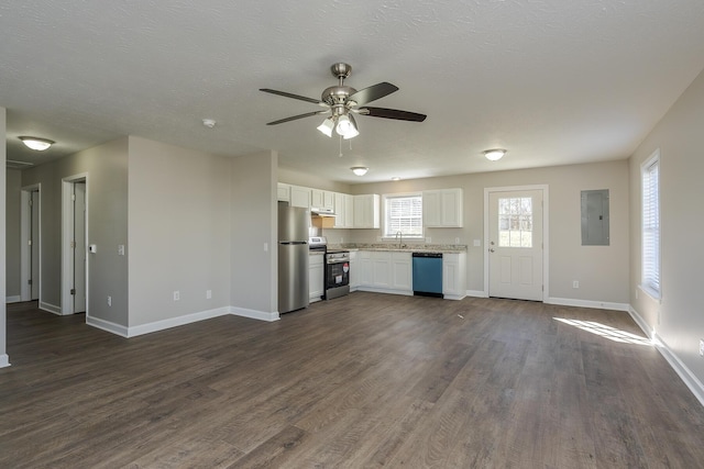 kitchen featuring appliances with stainless steel finishes, sink, white cabinets, dark hardwood / wood-style flooring, and electric panel