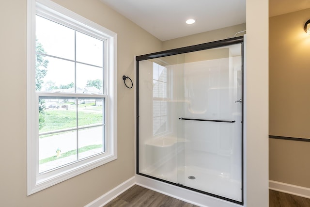 bathroom featuring an enclosed shower and hardwood / wood-style flooring