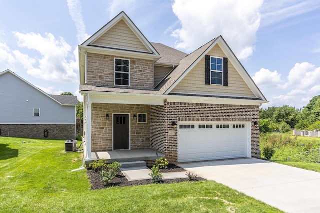 view of front of property featuring a garage, central AC, and a front yard