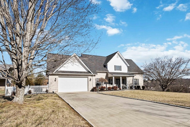 view of front of house featuring a garage, a porch, and a front yard