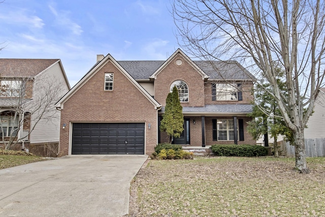 traditional-style house featuring driveway, roof with shingles, a garage, and brick siding