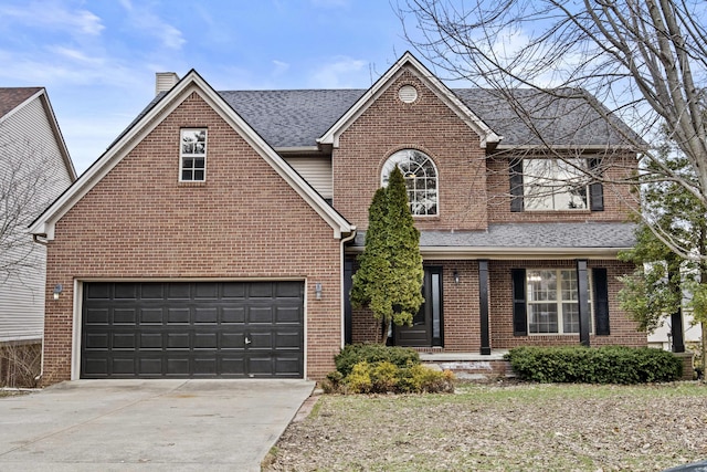 traditional-style home with a garage, concrete driveway, brick siding, and a chimney