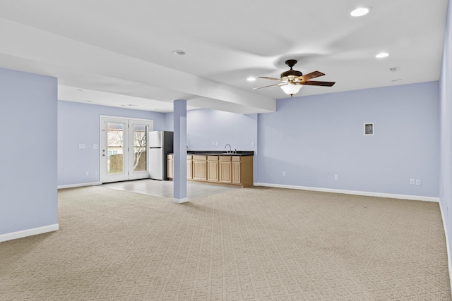 unfurnished living room featuring recessed lighting, light colored carpet, ceiling fan, and baseboards