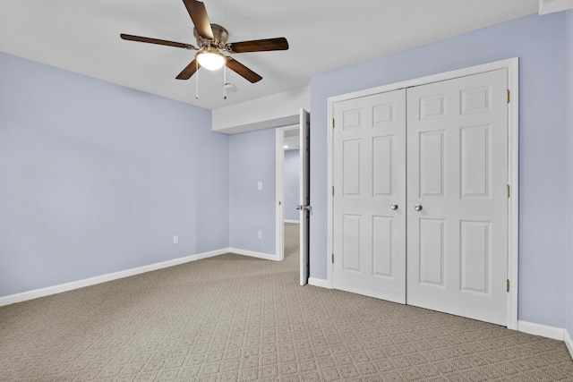 unfurnished bedroom featuring light carpet, ceiling fan, baseboards, and a closet