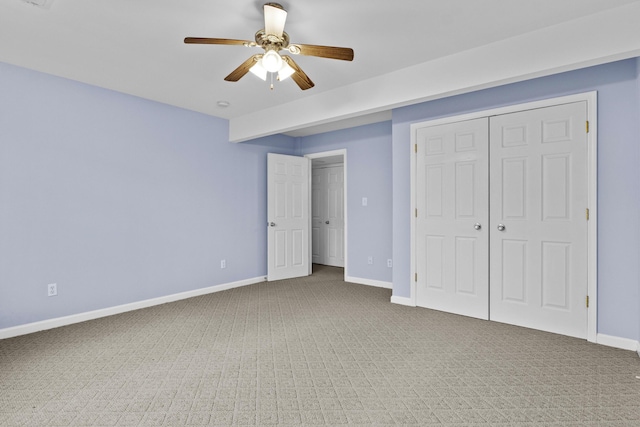 unfurnished bedroom with a ceiling fan, carpet, baseboards, and a closet