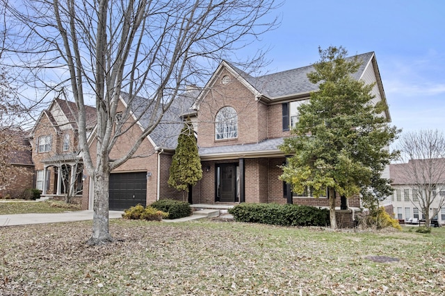 traditional-style house with a garage, concrete driveway, brick siding, and a shingled roof