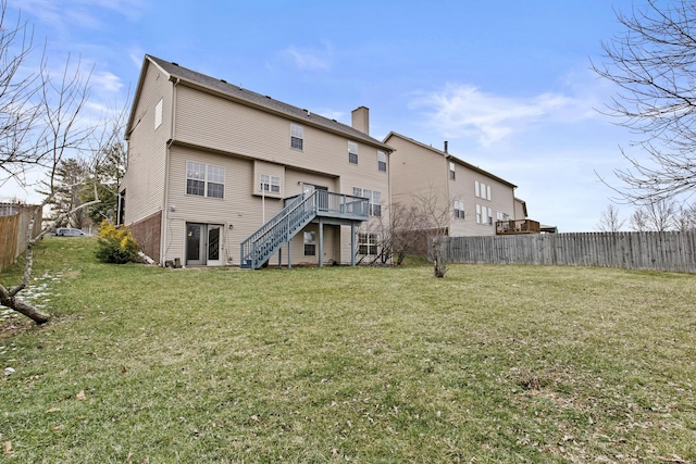 rear view of house with stairs, a yard, a deck, and fence