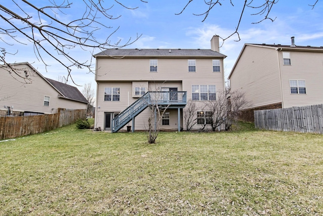 back of house featuring a yard, stairway, a chimney, and a fenced backyard