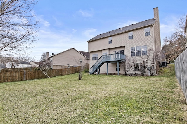 rear view of property featuring a fenced backyard, stairway, a yard, a wooden deck, and central AC