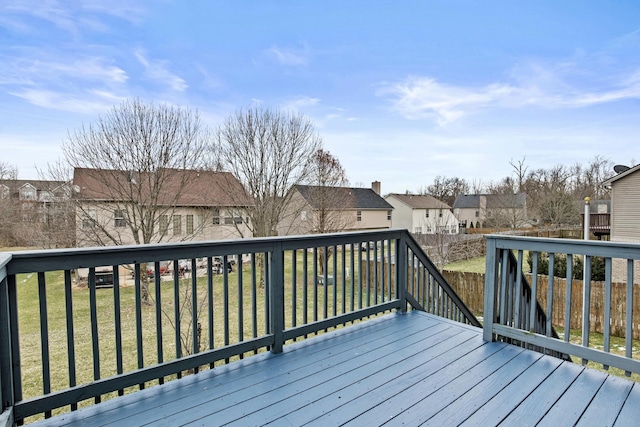 deck featuring a yard, fence, and a residential view