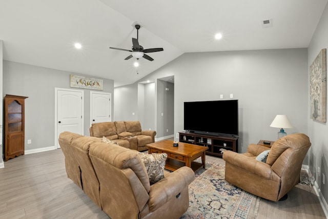 living room featuring vaulted ceiling, light hardwood / wood-style floors, and ceiling fan