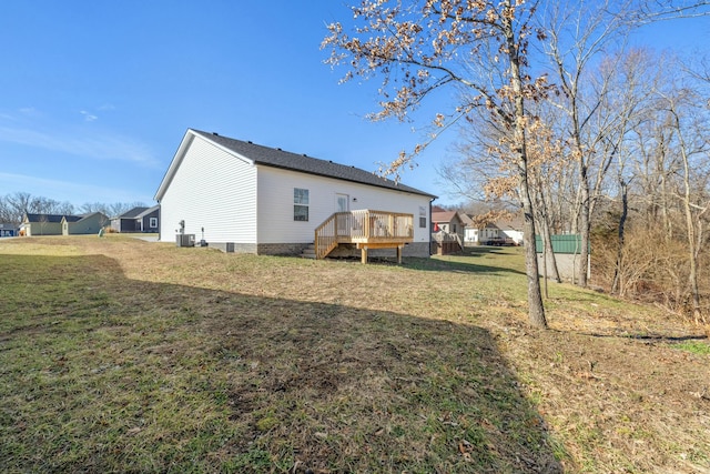 rear view of house with a deck and a lawn