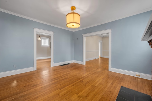 unfurnished room with ornamental molding and light hardwood / wood-style floors