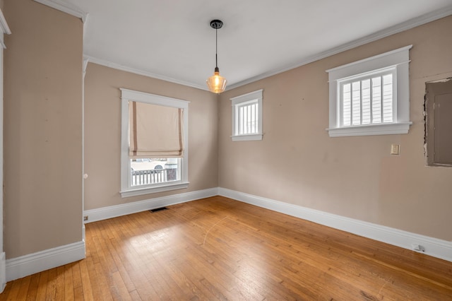 unfurnished room with hardwood / wood-style floors and ornamental molding