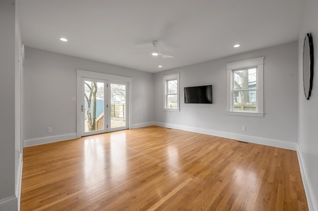 unfurnished living room with ceiling fan and light wood-type flooring