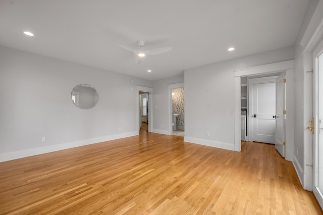 empty room with ceiling fan and light hardwood / wood-style flooring