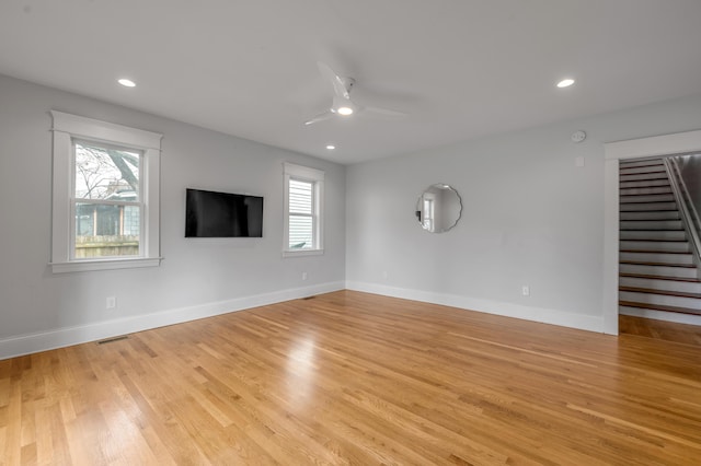 unfurnished living room featuring ceiling fan and light hardwood / wood-style floors