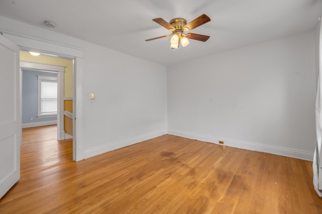 spare room with ceiling fan and light wood-type flooring