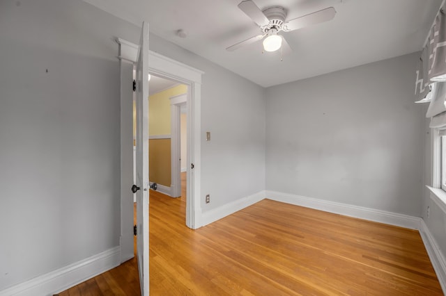 empty room with wood-type flooring and ceiling fan