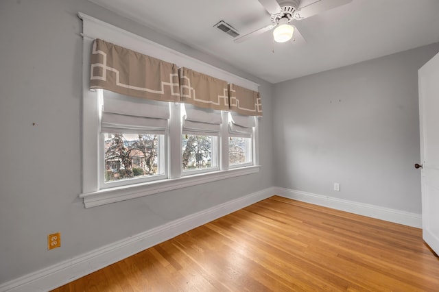 spare room with hardwood / wood-style floors and ceiling fan