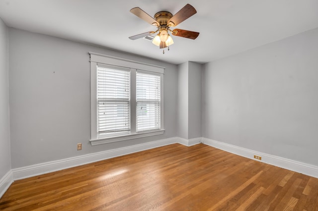 empty room with wood-type flooring and ceiling fan