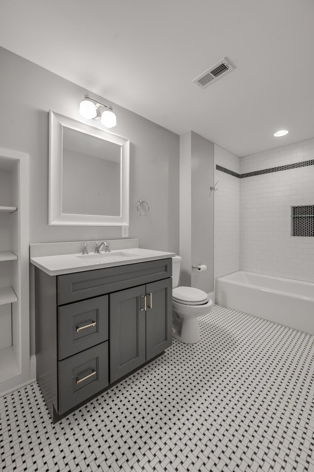 full bathroom featuring vanity, toilet, and tiled shower / bath