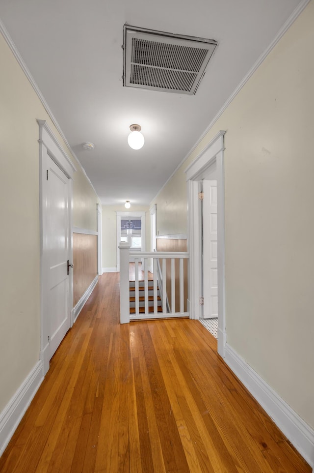 corridor featuring hardwood / wood-style flooring and crown molding