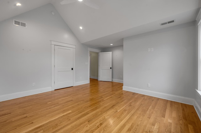 empty room with high vaulted ceiling, light hardwood / wood-style floors, and ceiling fan